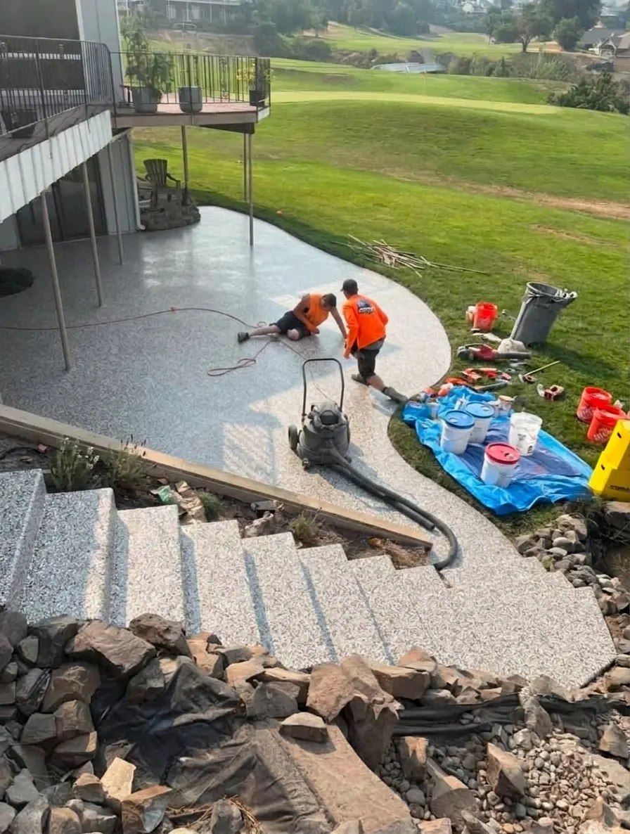 AI preview: A contractor's concrete patio and steps with the crew prepping the slab, then the same photo in Creek Bed flake