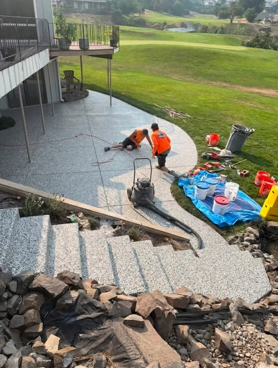 AI preview: a contractor's curved backyard patio, walkway and steps below a deck